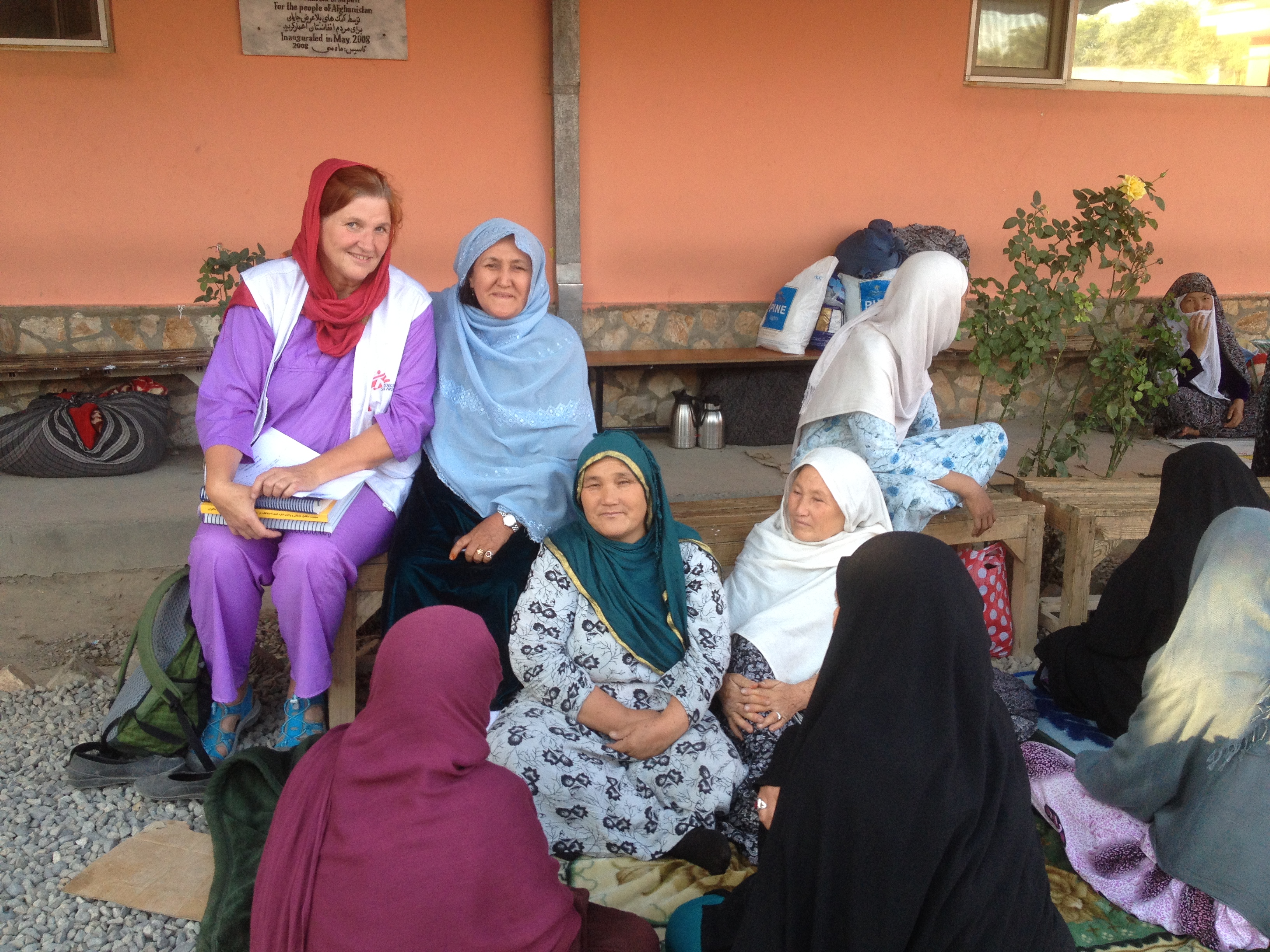 utanför mödravårdskliniken med de äldra kvinnorna som väntar på släktingar som ska föda