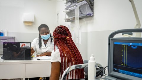 En läkare talar med en patient på Läkare Utan Gränsers vårdcentral i Aten