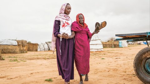 En anställd från Läkare Utan Gränser går med en patient.
