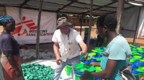 MSF staff handing out water and sanitation supplies in Malawi