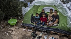En familj sitter i sitt tält utanför flyktinglägret Moria på Lesbos, Grekland