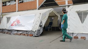 En personal från Läkare Utan Gränser passerar triagetältet för covid-19 utanför ett sjukhus i Caracas, Venezuela.