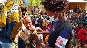 En kvinna från Läkare Utan Gränser mäter överarmen på ett litet barn med måttbandet MUAC i Meluco , provinsen Cabo Delgado i Moçambique.