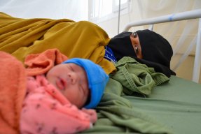 Zaima Hussain ligger i sängen med sin nyfödda Aiesha på sjukhuset i al-Qanawis, Jemen.