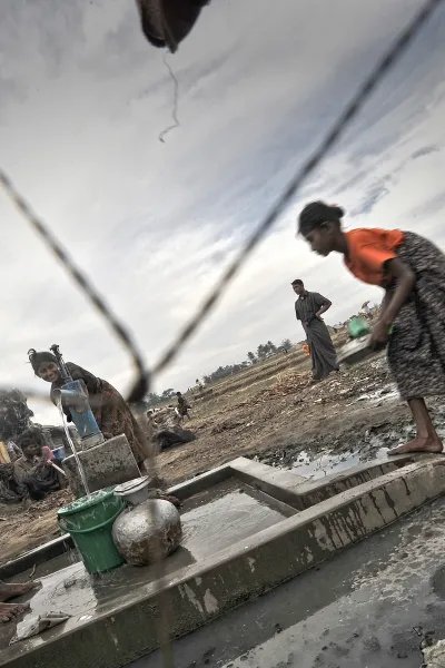 Internflyktingar tillhörande den diskriminerade och förföljda folkgruppen Rohingya hämtar vatten ur en pump i ett läger utanför Sittwe i Myanmar. 