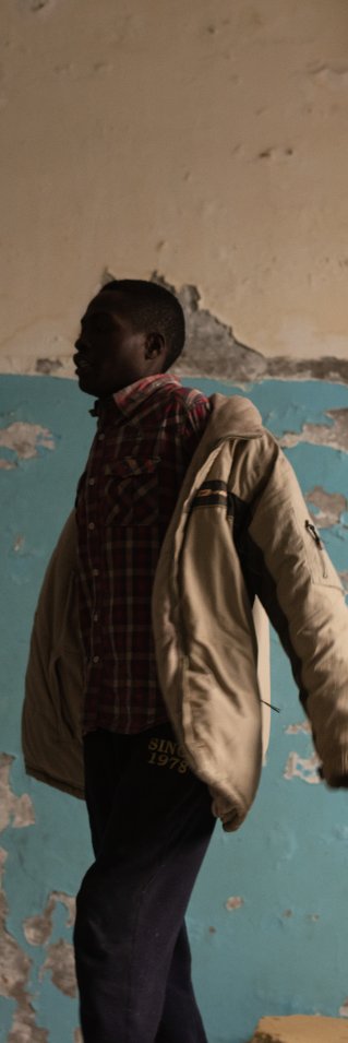 En man tar på sig en kavaj.