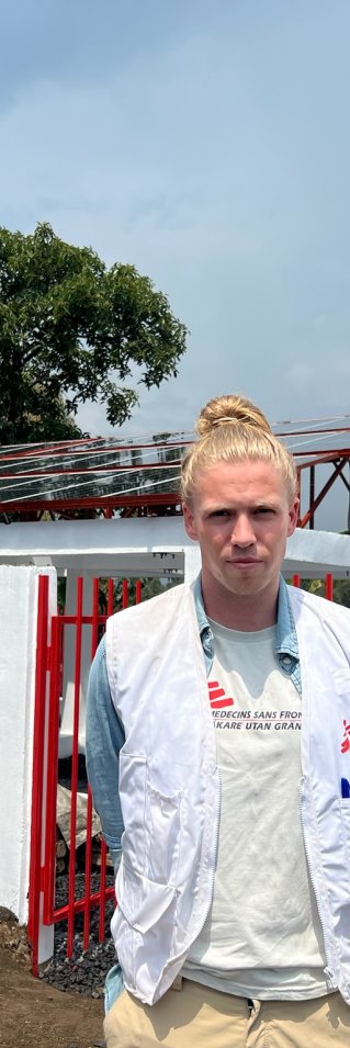 Porträttbild av Zacharias Edholm framför en byggnad.