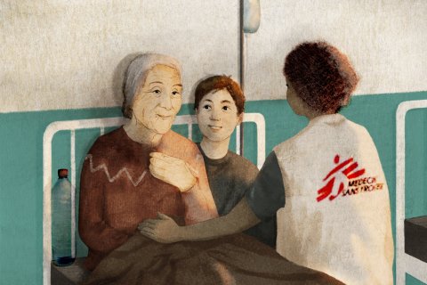 Äldre kvinna sitter i en sjukhussäng med en sjuksköterska bredvid sig