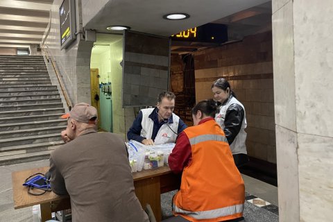 Läkaren Morten Rosrup sitter vid ett bord i Charkivs tunnelbana där Läkare Utan Gränser ger grundläggande vård och stöd.